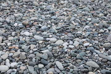 Surface covered with many different pebbles as background