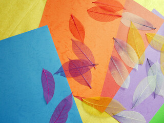 Background of colorful papers and leaves.