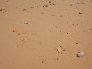 Background of rocks and pink sand on the beach seashore
