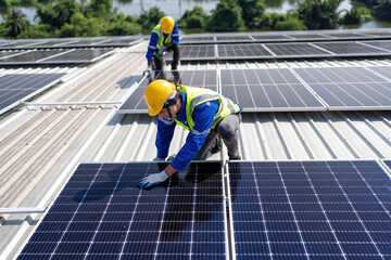 Engineer on rooftop kneeling next to solar panels photo voltaic with tool in hand for installation