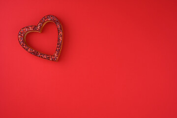 Sparkly red heart shaped frame on a red background, celebrating love on Valentine’s Day
