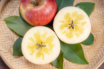 Honey Apple on bamboo basket, Apple with honey core on wooden background.