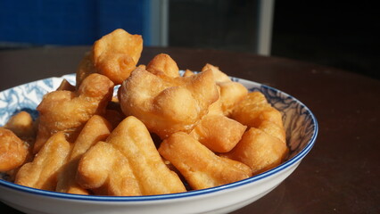 The breakfast made from fried flour is called Patongo on plate. Chinese Bread Stick, 