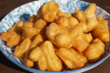 The breakfast made from fried flour is called Patongo on plate. Chinese Bread Stick, 