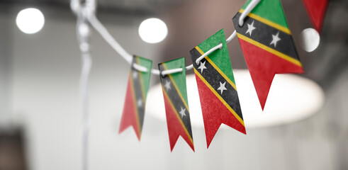 A garland of Saint Kitts and Nevis national flags on an abstract blurred background