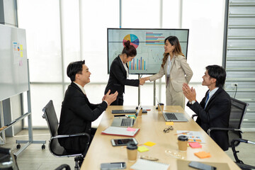 group of business people meeting in boardroom team leader woman presenting ideas on whiteboard discussing strategy with colleagues in office