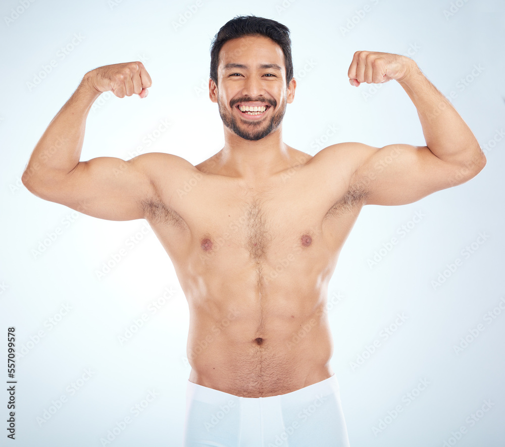 Wall mural Fitness, biceps and portrait of a man flexing in a studio after an arm muscle training workout. Sports, health and strong Asian male bodybuilder after a strength exercise isolated by white background