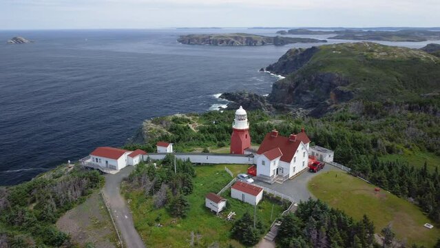 A panning reveal of the coastline by Long Point Lighthouse at Crow Head, near Twillingate, Newfoundland and Labrador