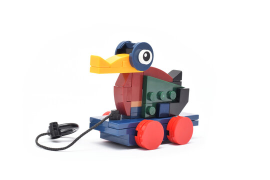 Lego historical toy duck made from plastic bricks isolated on white. Editorial illustrative image of 90 years of popular brand of children toys.