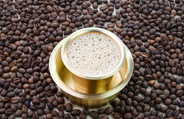 Indian filter coffee in a brass cup.