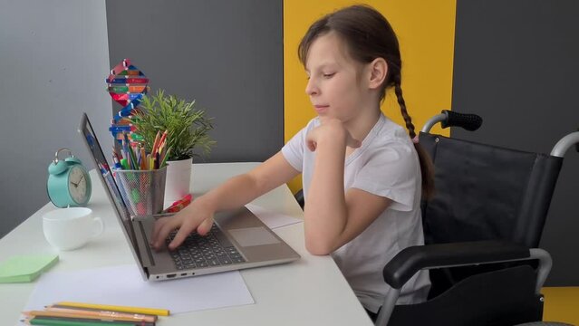 Disabled girl in wheelchair with laptop at home. Distance learning education and disability