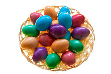  painted eggs close-up in a wicker bowl on a white background.Easter food. Spring religious holiday symbol. Easter tradition. Christian and Catholic tradition holiday.