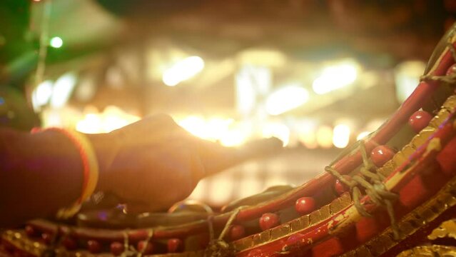 Musician playing Thai classical traditional music on Thai Xylophone or Khong mon or Pat kon or La gyan hsaing or Kong mon or Pi Phat or Gong Mon or graduated brass gong chime