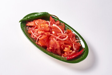 tomato and onion achuchuk salad on a white background