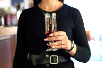 alcoholic cocktail in the girl's hand