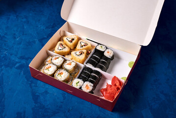 japanese rolls, sushi four kinds in a cardboard box for food delivery