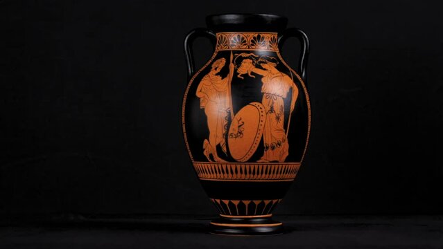 Dolly of a replica Greek Amphora or Vase that tells the myth of Perseus giving the head of Medusa to Athena - Wide Left to Right