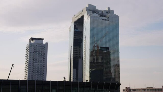 Umeda Sky Building Reflecting Construction of New Skyscraper in Osaka, Japan