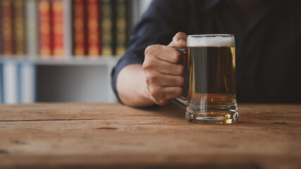 Man holding a glass of brandy, he is drinking brandy in a bar, drinking alcohol impairs driving...