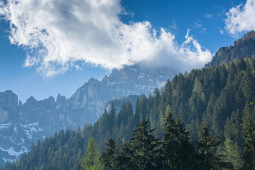 View in the Dolomites on mountains and a cloud on a blue sky