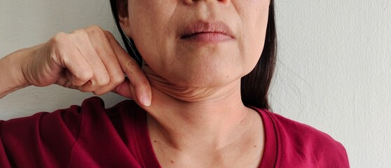 portrait the flabbiness adipose sagging skin beside the neck, wrinkles and flabby skin, wattle and rough skin under the chin of Middle-aged woman, health care and beauty concept.