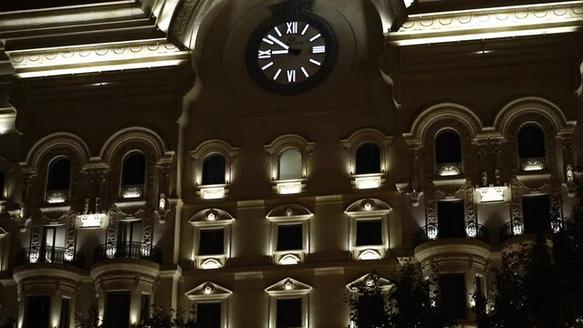 Baku Azerbaijan at Night. Clock and Exterior of Vintage Building in Lights