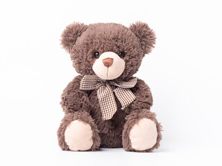 Brown teddy bear doll and sitting on white background.