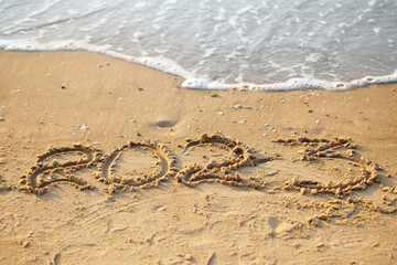 Sand writing 2023, New Year holidays concept
