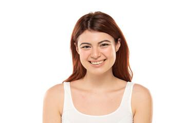 Portrait of smiling beautiful woman with long straight ginger hair on a white background