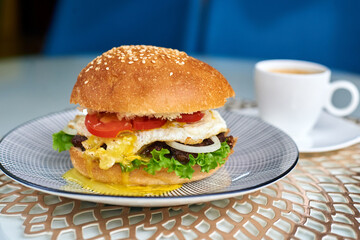 burger in a plate with a cup of coffee