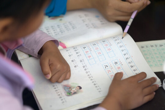 A little girl reading and studying