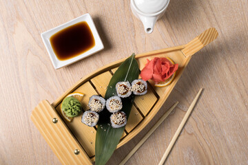 japanese sushi, rolls on a wooden structure
