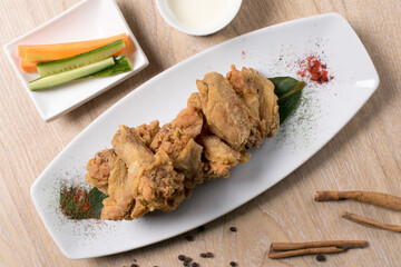 fried vegetables salted cucumbers sauce in a white plate