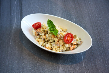 Olivier salad on a marble background