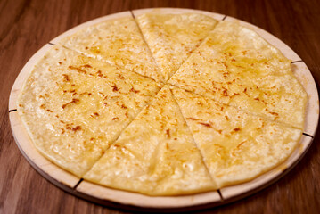 a dish of khinkali, on a wooden background