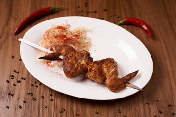 kebab of chicken wings, on a wooden background