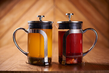 green and black tea on a wooden table and background