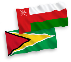 National vector fabric wave flags of Sultanate of Oman and Co-operative Republic of Guyana isolated on white background. 1 to 2 proportion.