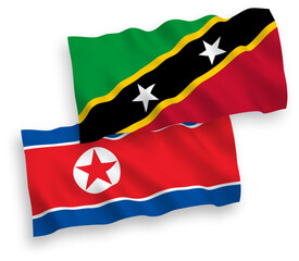 National vector fabric wave flags of North Korea and Federation of Saint Christopher and Nevis isolated on white background. 1 to 2 proportion.
