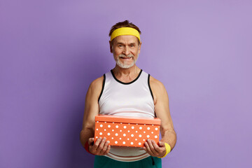 Birthday Present. Senior Man Unboxing Gift Box. Portrait of Handsome Bearded Grandfather Posing...