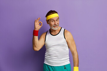 Ok Gesture. Mature Man Making Ok Symbol With Fingers, Approving, Satisfied. Indoor Studio Shot Isolated On Violet Background 