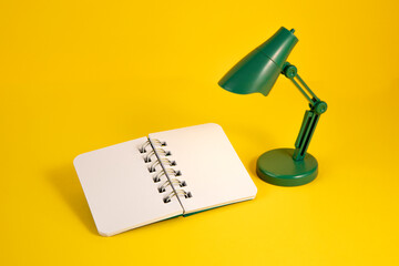 Small notebook mockup with a toy lamp on yellow background
