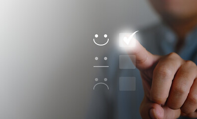 Customer service and satisfaction concept, businessman touching virtual screen on icon to give service satisfaction very impressive score