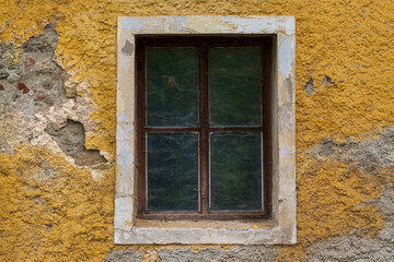 Fototapeta na wymiar Old wooden window. Around the window is the plaster of the old house.
