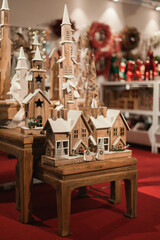 Wooden castle toy constructor at Christmas market vertical shot. Vintage festive wood home decor on holiday season.