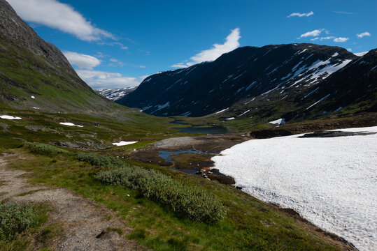 Snow capped mountains and crystal clear lakes along the Sognefjellsvegen, highest mountain road of Northern Europe, Jotunheimen National Park, Norway