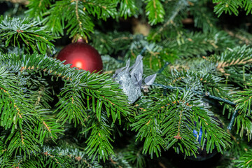 grey dow Christmas tree ornament on a Christmas tree