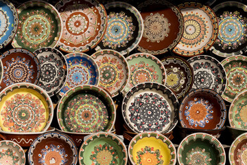 Modern Bulgarian ceramics. A shop with pottery. Plates painted in folk style.