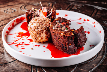 Chocolate Brownie cake with Vanilla Ice Cream on black plate