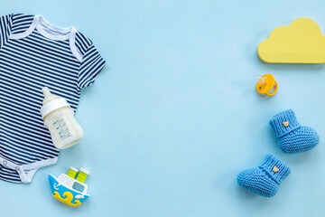 Baby cotton bodysuit with toys flat lay, top view